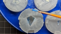 Close-up of mica powder being applied to the molds.